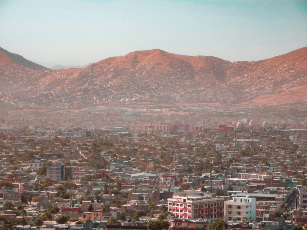 a view of a city with mountains in the background